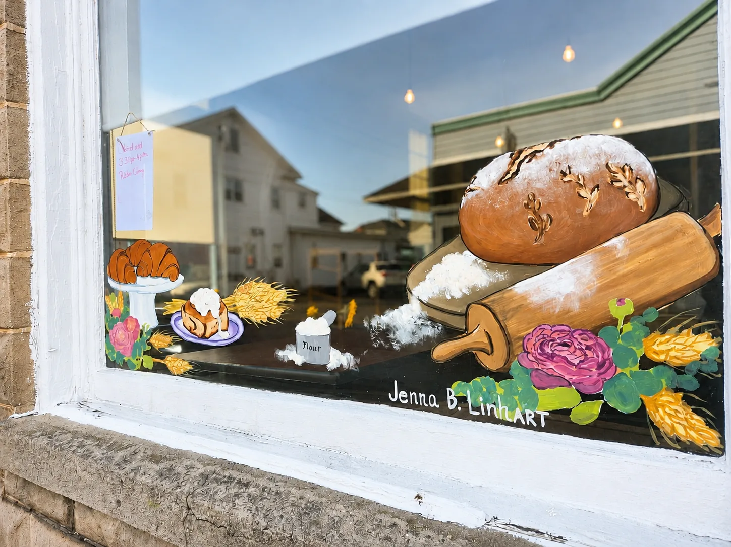 The hand-painted mural on the bakery's front window